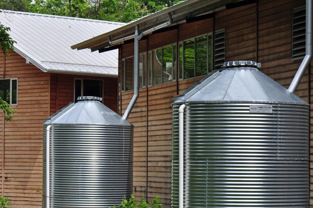 Rain water collection tanks behind a house
