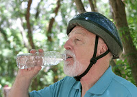 elder man drinking water from bottle